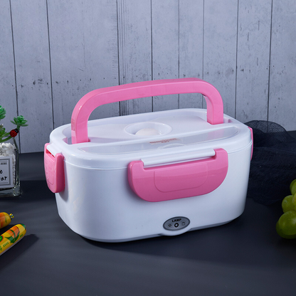 White and pink electric lunch box on a dark surface with a light gray wooden background