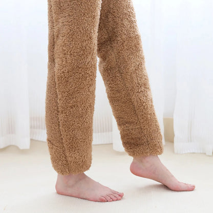 Brown fuzzy pants worn by a person on a light-colored floor with white curtains in the background.