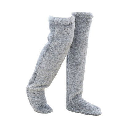 Gray fuzzy knee-high socks on a white background