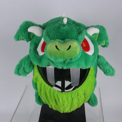 Green plush toy with red eyes and white horns on a white background
