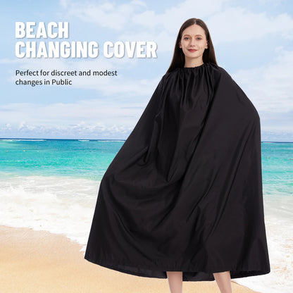 Woman wearing a black beach changing cover on a beach with ocean view