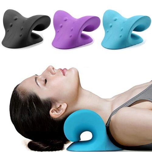 Woman using a blue neck pillow with three other neck pillows in black, purple, and blue above her.