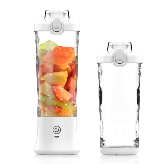 Portable fruit juice maker with fruits inside and a clear container on a white background