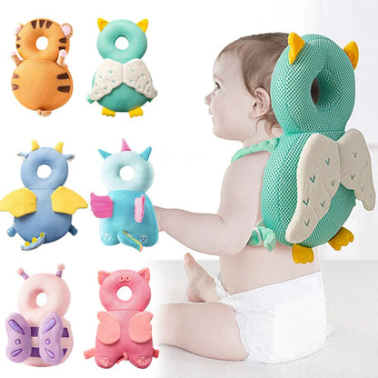 Baby with a green owl-shaped head support and various colorful animal-themed toys on a white background