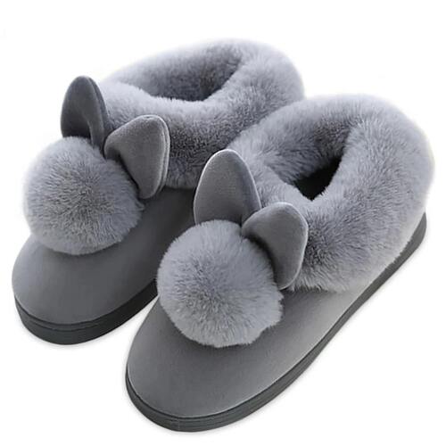 Gray slippers with fuzzy pom-poms on a white background