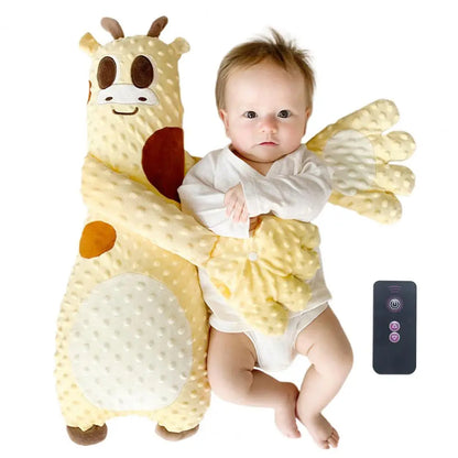 Baby in a giraffe costume with a remote control on a white background
