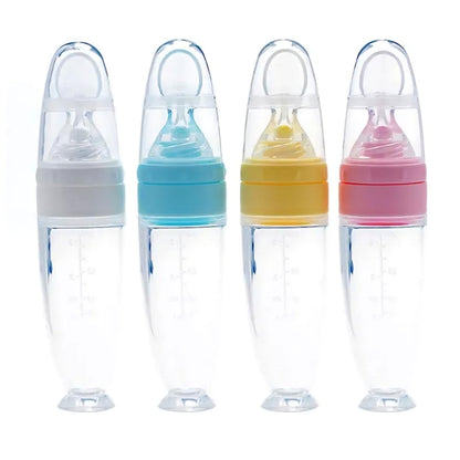 Four baby bottles with colorful caps on a white background