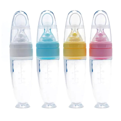 Four baby bottles with colorful caps on a white background