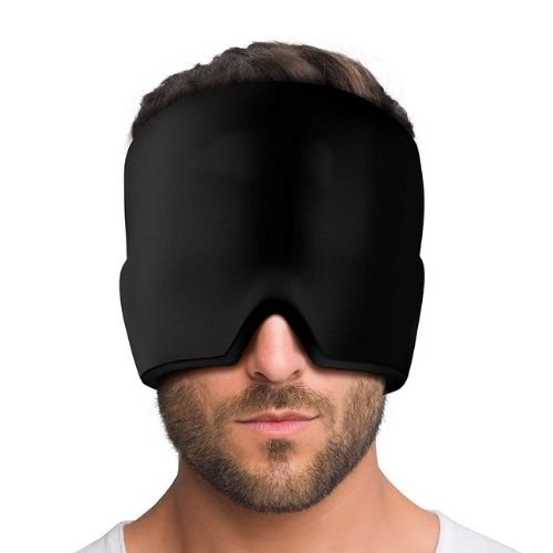 Person wearing a black sleep mask on a white background