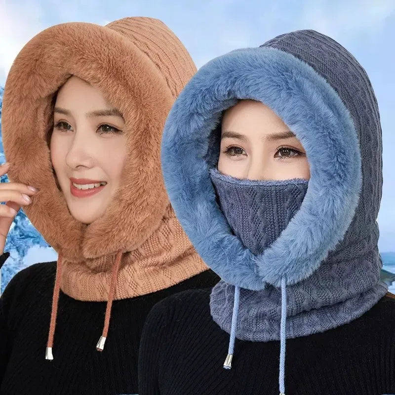 Two people wearing knitted hoods in brown and blue against a blurred outdoor background.
