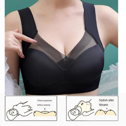 Black bra with mesh panels worn by a person, on a teal background