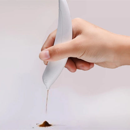 Hand holding a spoon with a small amount of brown powder on a light gray background