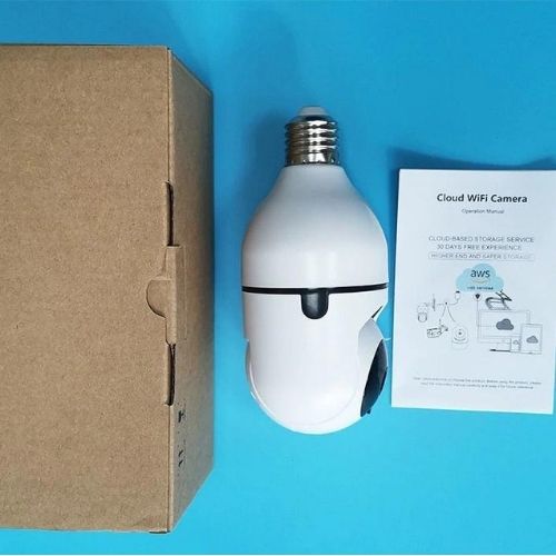 White cloud-shaped WiFi camera next to a cardboard box and manual on a blue background
