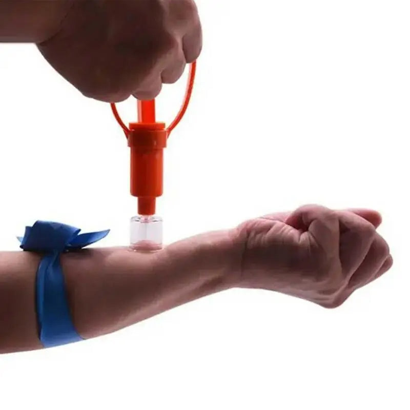 Person using a blood collection device on their arm with a blue bandage.