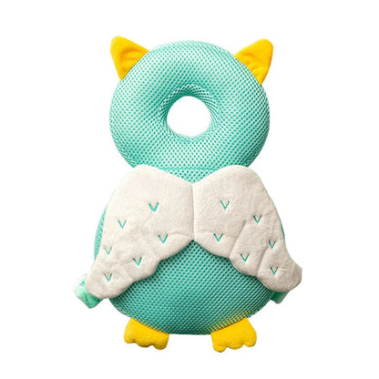 Teal owl-shaped pillow with yellow accents on a white background