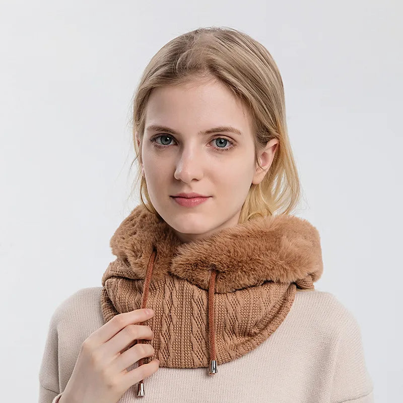 Woman wearing a brown knitted scarf with fur trim against a white background