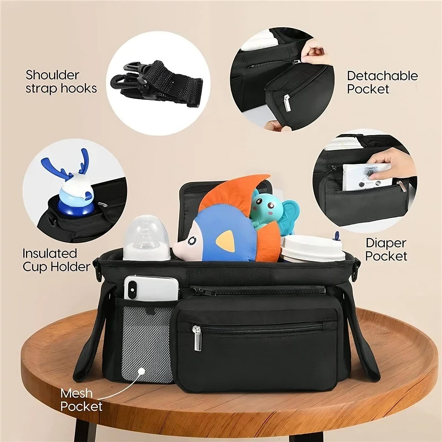 Black diaper bag with various compartments and features highlighted on a beige background
