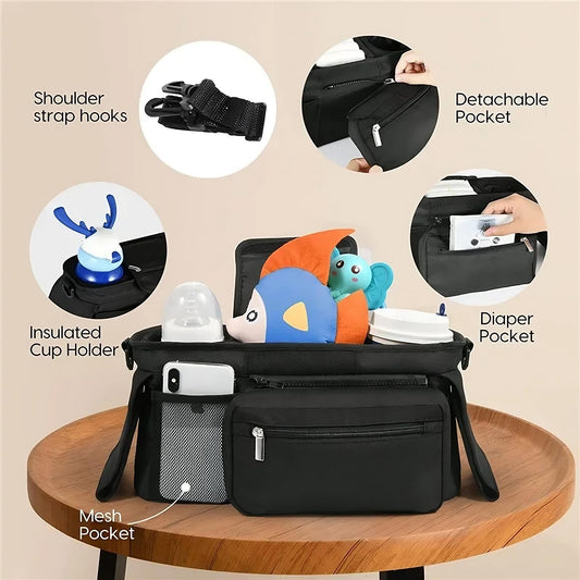 Black diaper bag with various compartments and features highlighted on a beige background