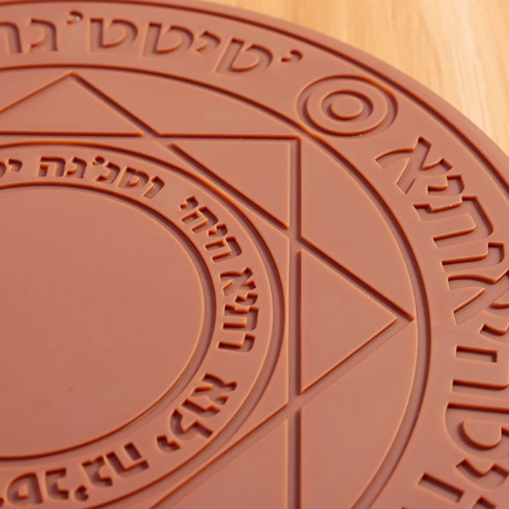 Close-up of a brown circular object with embossed text and design on a wooden surface