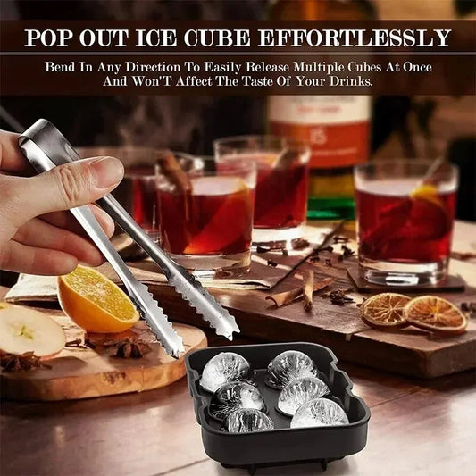 Ice cube tray with tongs and glasses of drinks on a table
