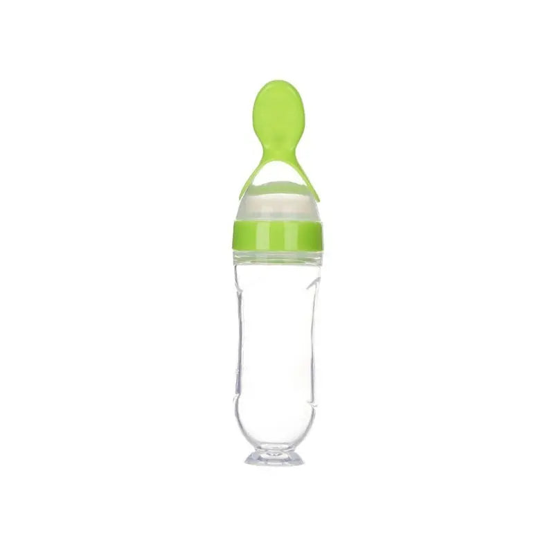 Clear baby bottle with green cap and handle on a white background