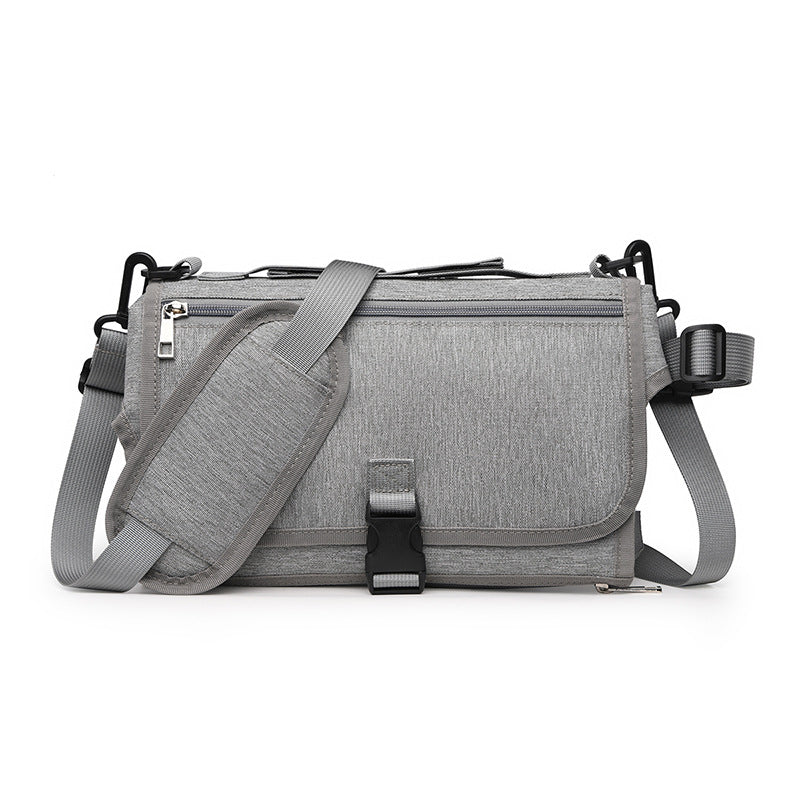 Gray shoulder bag with a strap on a white background