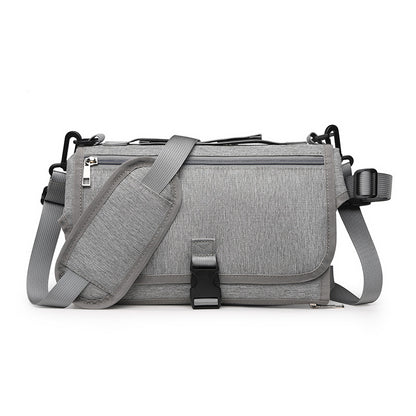 Gray shoulder bag with a strap on a white background