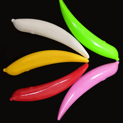 Five colorful plastic bananas on a black background