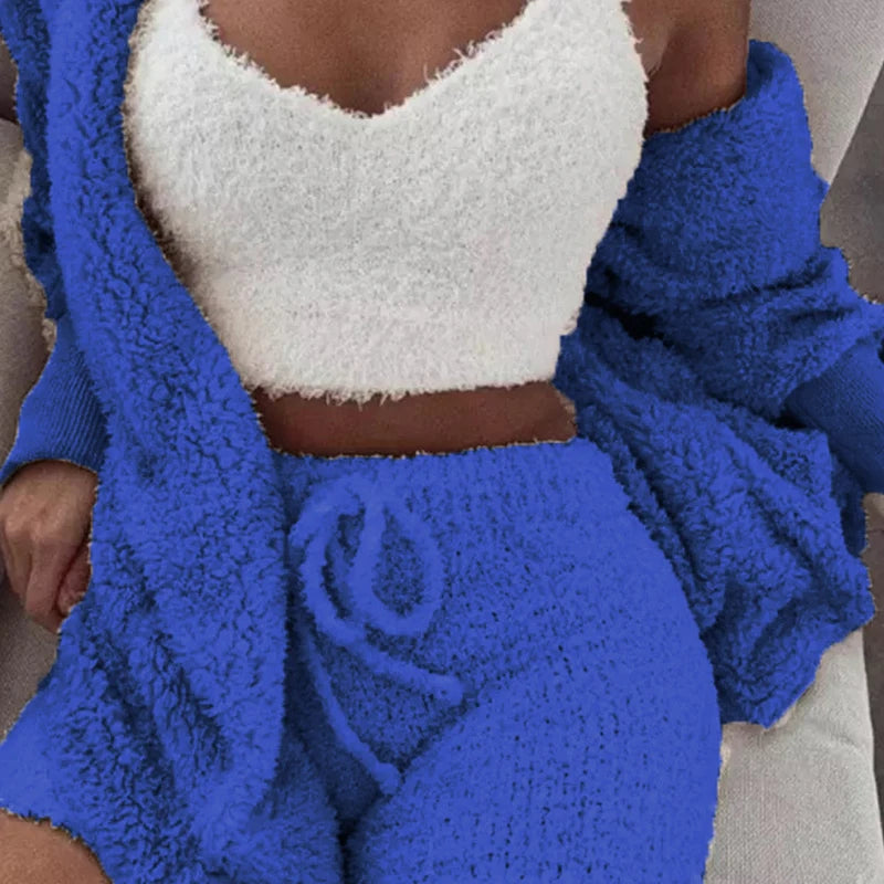 Person wearing a blue and white textured outfit with a blanket draped over them.