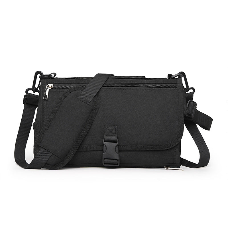 Black shoulder bag with multiple zippers on a white background