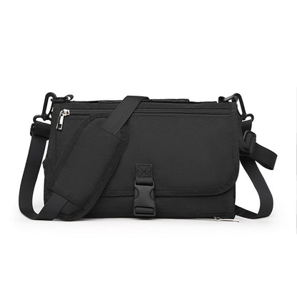 Black shoulder bag with multiple zippers on a white background