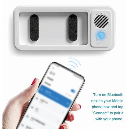 White electronic device with Bluetooth connectivity feature, shown with a smartphone.