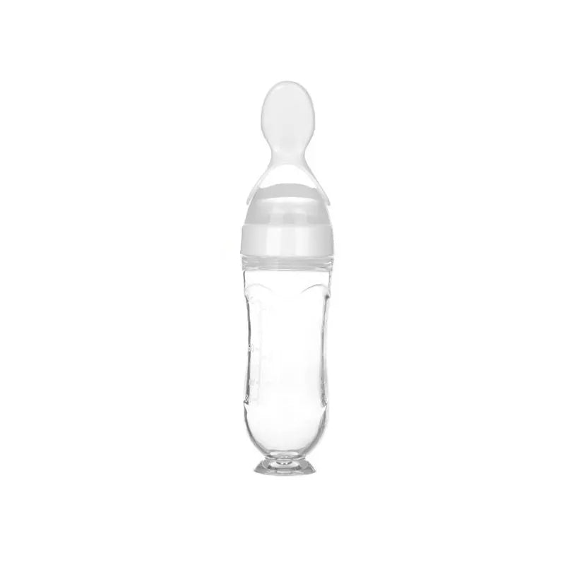 Clear baby bottle with a white cap on a white background