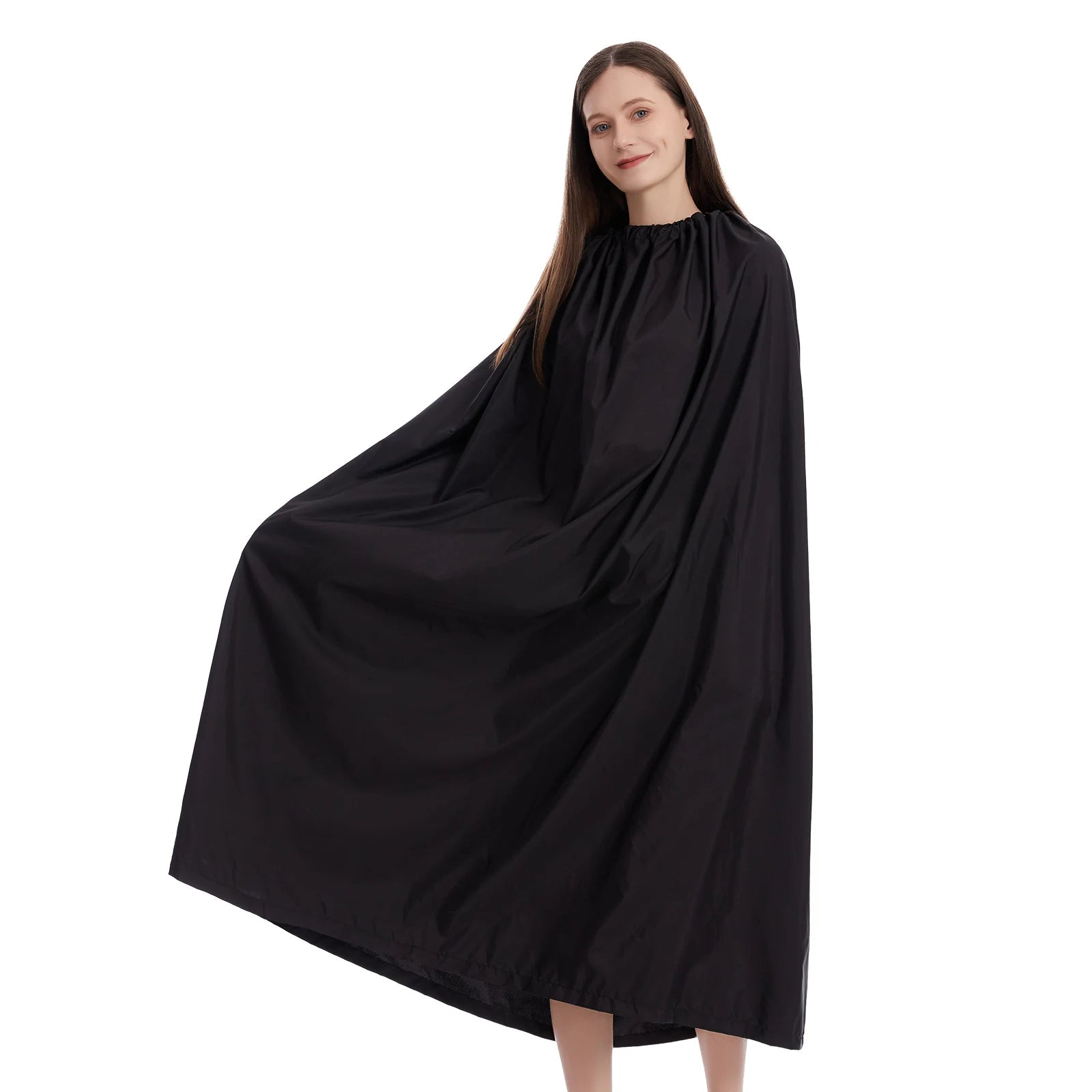 Woman wearing a black hairdressing cape on a white background