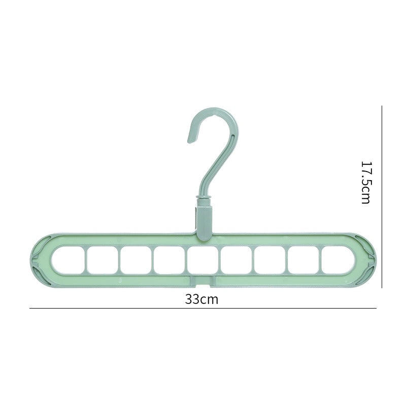 Green plastic hanger with multiple hooks on a white background