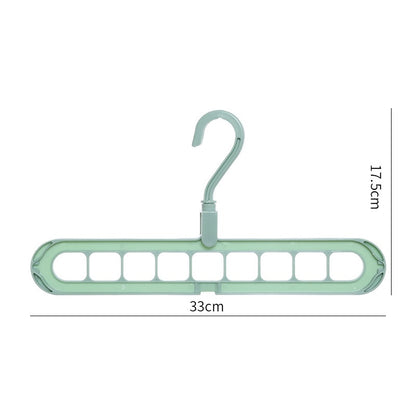 Green plastic hanger with multiple hooks on a white background