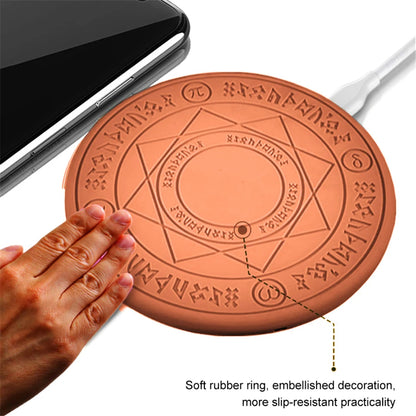 Round rubber mat with engraved design, held by a hand, next to a smartphone and cable.